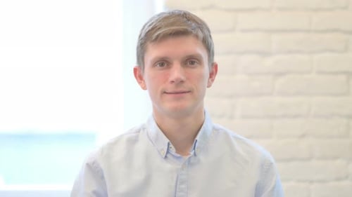 Close Up of Young Man Smiling at Camera