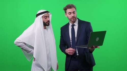 Businessmen Discussing Laptop Content on Green Screen