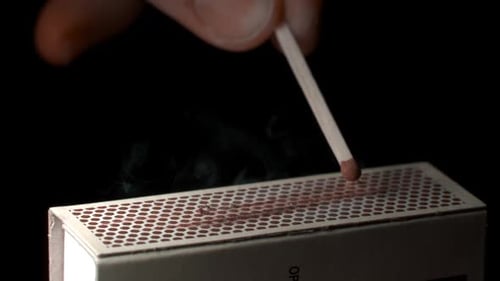 Match Ignites Against Matchbox in Macro Detail