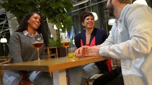 Multiracial Friends Taking Drinking Beer in a Night Bar Terrace