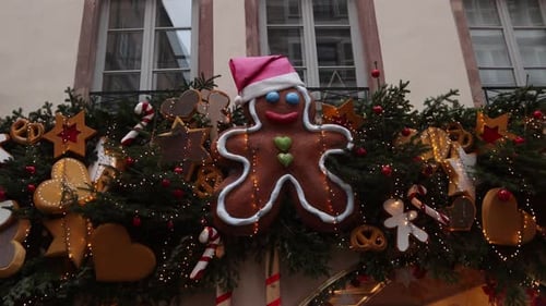 Gingerbread man decoration with santa hat above a storefront in a Festive Christmas market in Europe