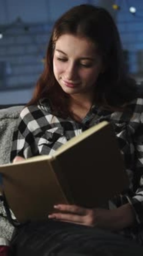 Attractive Young Girl Reading Notes In Notebook In An Evening Room