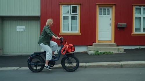 Cute Young Woman Ride City Ebike on Summer Street