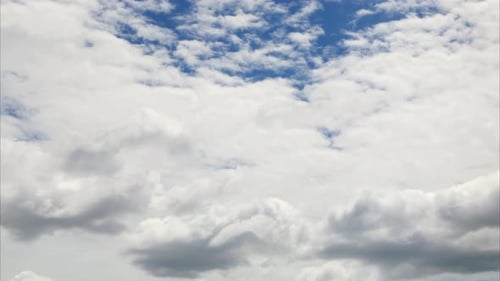 Puffy fluffy white clouds. Cumulus cloud cloudscape. Summer blue sky time lapse.