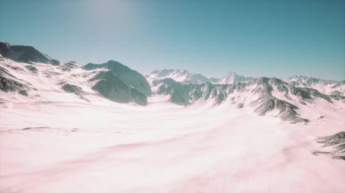 Flying Over Vast Snowy Mountain Range Landscape