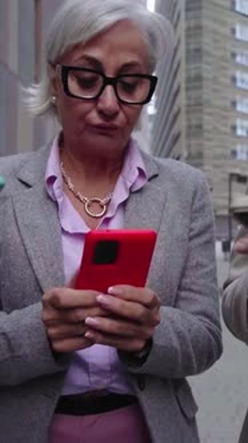 Professionals Using Mobile Phones on City Street