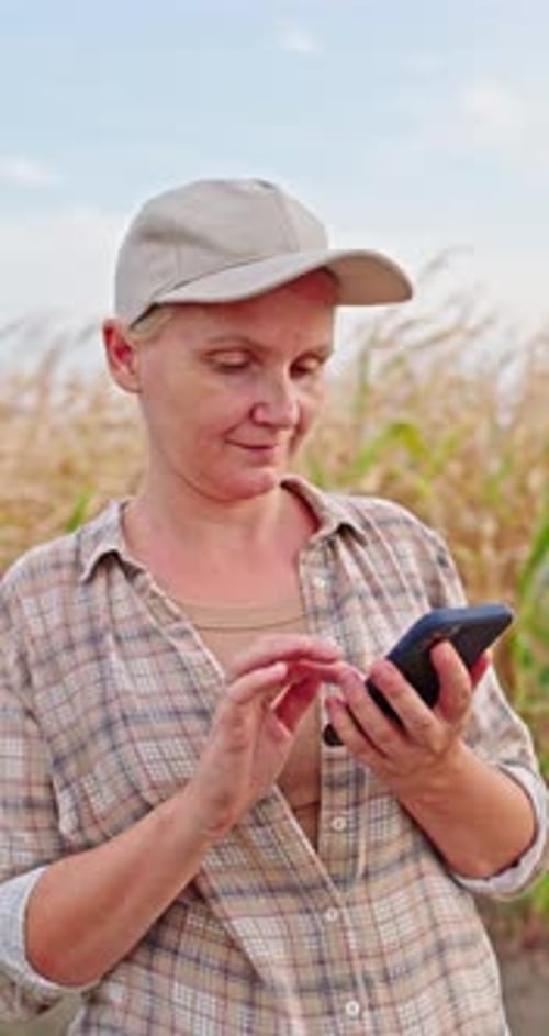 Farmer Using Smartphone in Corn Field