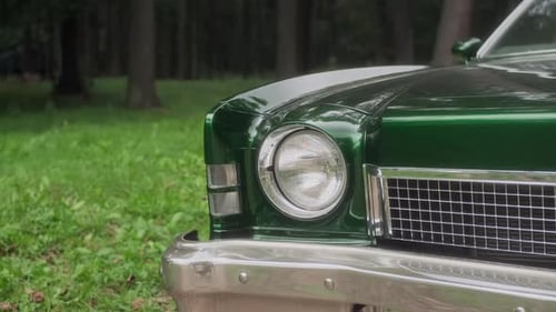 Detailed Shot of Headlight of Green Vintage Car Parked in a Park This Collectible Oldfashioned