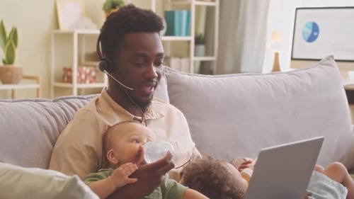Dad Feeds Baby While Working From Home