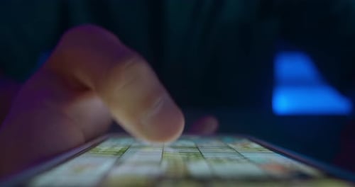 Hand Browsing Photos on a Mobile Phone