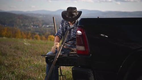 Farmer Sharpening Tool in Rural Setting