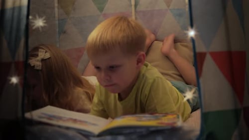 Children Reading a Book in a Cozy Tent