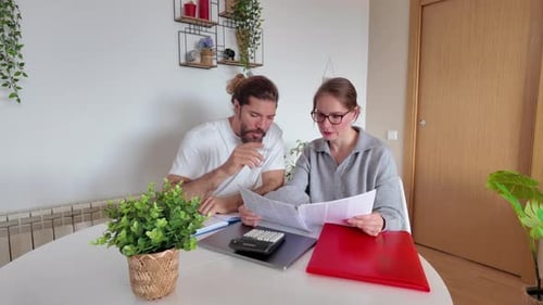 Man and Woman Review Finances at Table