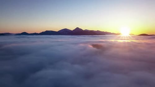 Sunrise Aerial View Fast Flight above Blue Clouds Nature