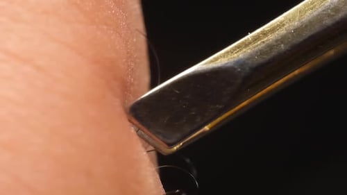 Macro View Slow Motion Tweezer Pulls Out A Strand Of Hair