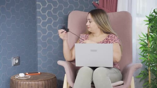 Woman Working on Laptop, Plugs in Charger