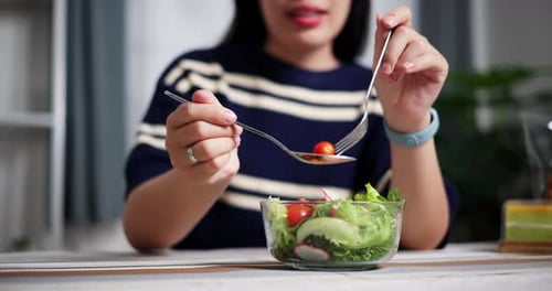 Young Adult Preparing a Healthy Salad at Home