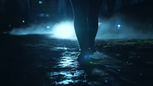 A People Walking in the Dark Through the Fog and Darkness After the Rain