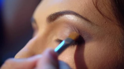 Woman Getting Eyeshadow Applied with Brush Close Up