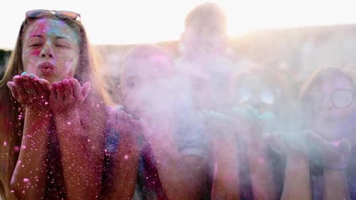 Friends Celebrate Holi Festival on Beach at Sunset