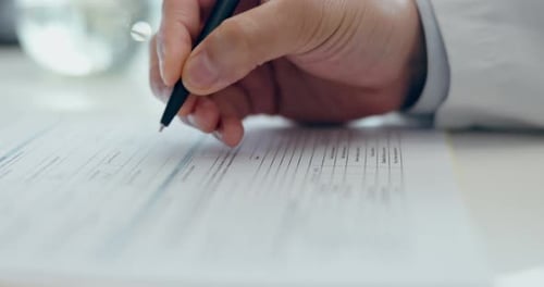 Hands, health insurance documents and doctor writing on table, paperwork