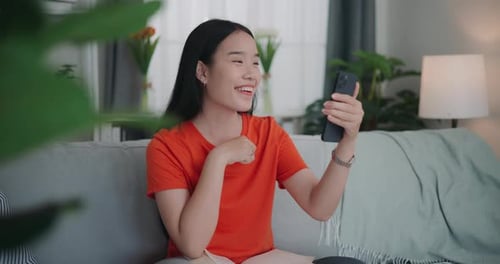 Smiling Woman Video Chatting on Smartphone at Home