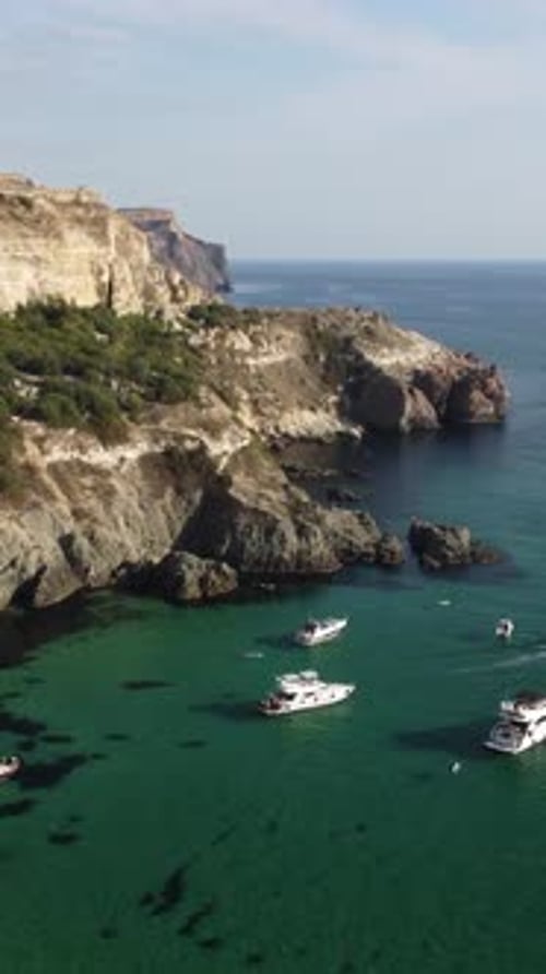 Aerial Vertical View of Seascape with Crystal Clear Azure Sea and Rocky Shores Yachts in a Beautiful