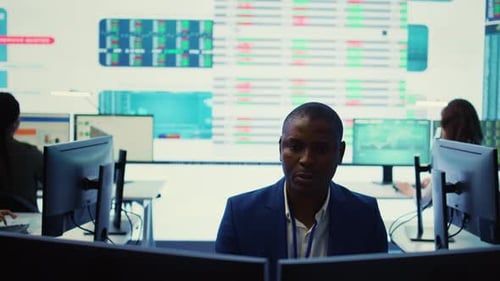 Busy Trading Floor Office with Data Screens