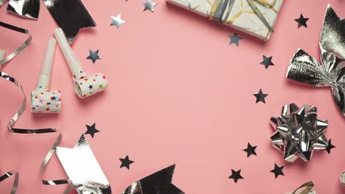 Top view accessories for a party or birthday on a pink background, spinning in a circle