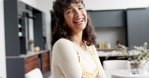 Smiling Woman with Apron Inside the Kitchen