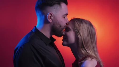Romantic Couple Embracing in Close Up with Red Lighting