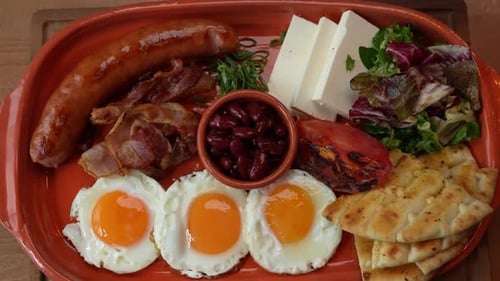 Hearty Breakfast Plate with Eggs, Sausage, and Beans
