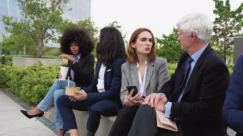 Multiracial business people with different ages having a lunch break outside office