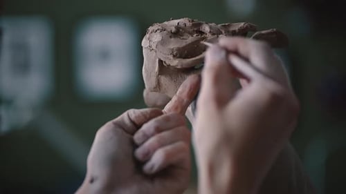 Closeup Sculptor Shapes Clay with Hands in Potting Workshop
