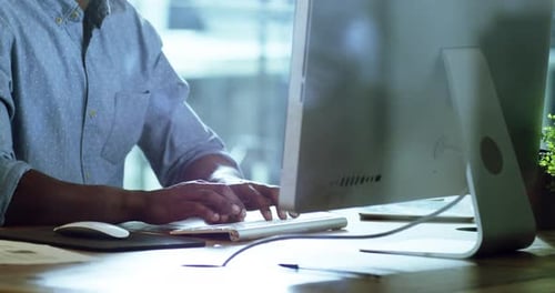 44k video footage of an unrecognizable businessman working late on a computer in an office