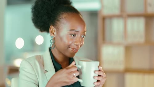 Smiling Woman Drinking Hot Beverage in Workplace