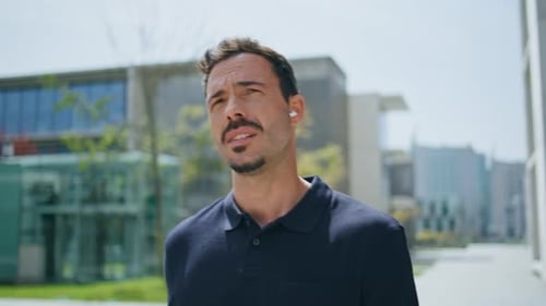 Serious Man Putting Earphones Strolling Sunny Street Closeup Boss Calling Phone