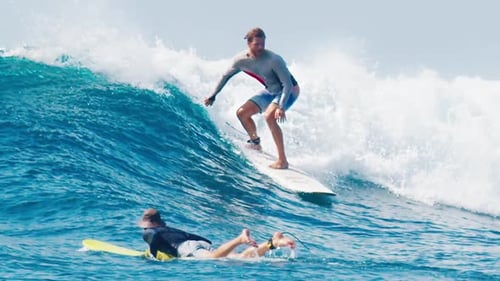 Man Surfs the Wave in the Maldives
