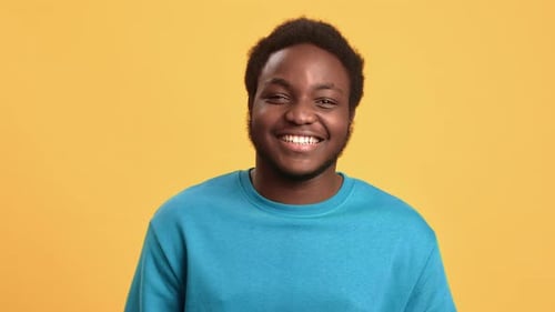 Portrait Overjoyed African American Young Guy Laughing with Positive Emotion Isolated on Orange