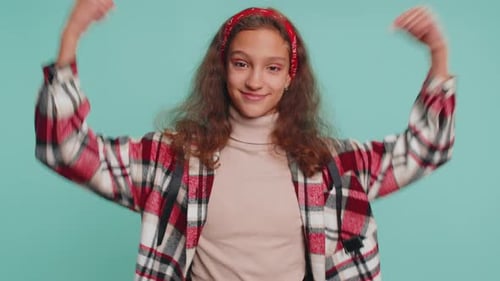 Young Teen Giving Thumbs Up on Blue Background