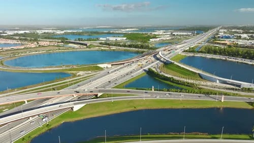 Aerial View of Highway Interchange Among Blue Lakes