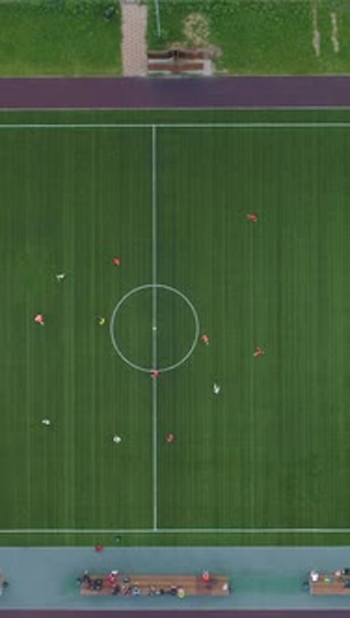 Flying Down Over Green Soccer Field Center Aerial Vertical Top View Vertical Video