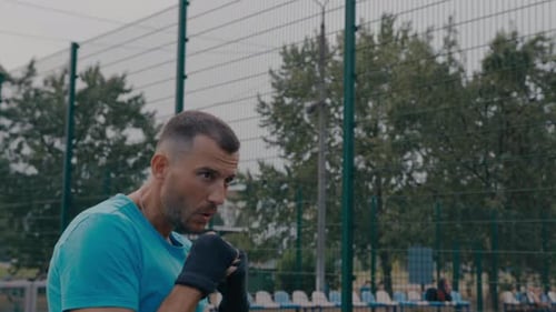 Man Shadow Boxing Outdoors in Urban Setting