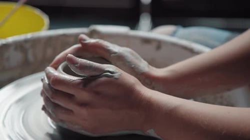 Hands Forming Clay Pot on Pottery Wheel