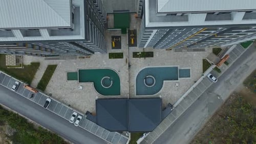 Aerial Video Cloudy Sky Highlights the Sleek Facade of a Modern Building Perfect for Urban Projects