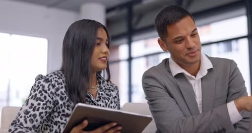 Colleagues Discussing Data on a Tablet in Office