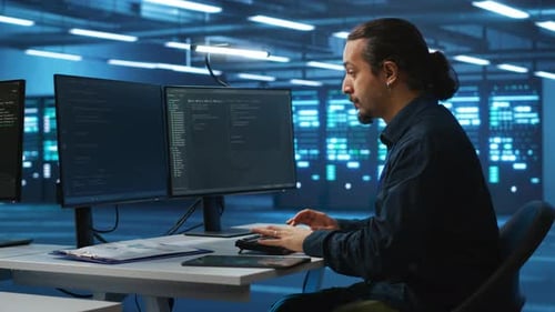 Specialist Working in High Tech Facility Doing System Analysis Coding