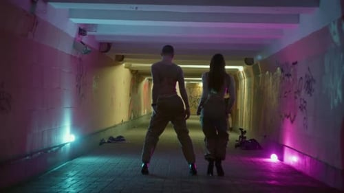 Young Man and Woman in High Heels Display Contemporary Dance in a Cityscape