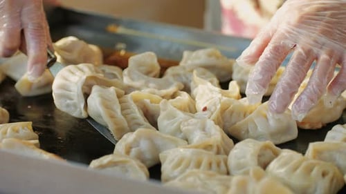 Cooking and Frying Asian Dumplings in a Restaurant