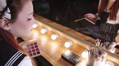 Woman Applying Makeup at Vanity with Cosplay Outfit